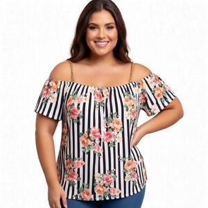 Women’s black and white blouse with floral print and detail with chain straps.